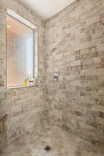 Full bathroom featuring a tile shower