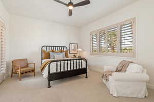 Carpeted bedroom with baseboards and ceiling fan