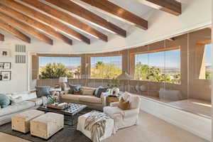 Living area featuring vaulted ceiling and carpet floors