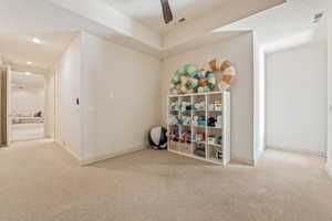 Recreation room featuring light carpet, ceiling fan, and recessed lighting