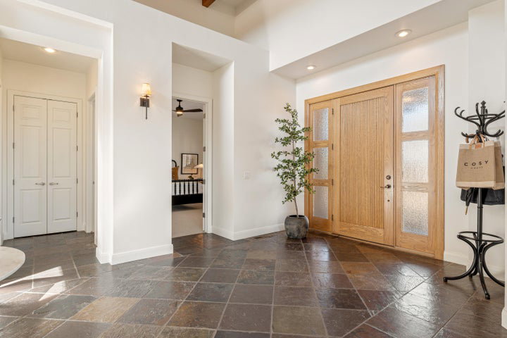 Foyer entrance with stone tile flooring, a ceiling fan, and recessed lighting