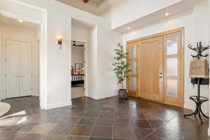 Foyer entrance with stone tile flooring, a ceiling fan, and recessed lighting