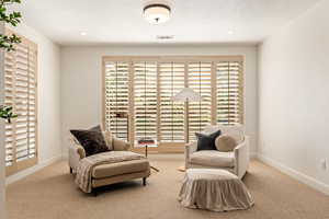 Living area featuring light colored carpet