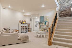 Living area with carpet flooring and recessed lighting