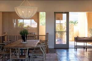 Dining area with stone tile floors and hanging lights