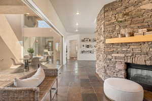 Foyer entrance with stone tile floors, a fireplace, and recessed lighting