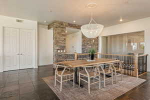 Dining area with stone tile flooring and recessed lighting