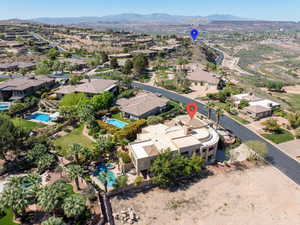 Aerial overview of property's location with a mountainous background and nearby suburban area