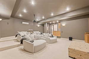 Home theater room with carpet flooring, a textured ceiling, and recessed lighting