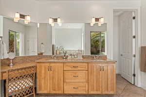 Bathroom featuring double vanity and light tile patterned floors