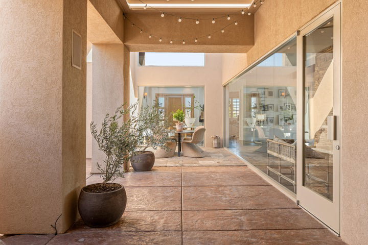 Doorway to property with stucco siding and a patio area