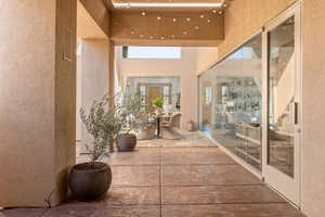 Doorway to property with stucco siding and a patio area
