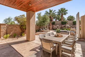 Fenced backyard with outdoor dining area and a patio