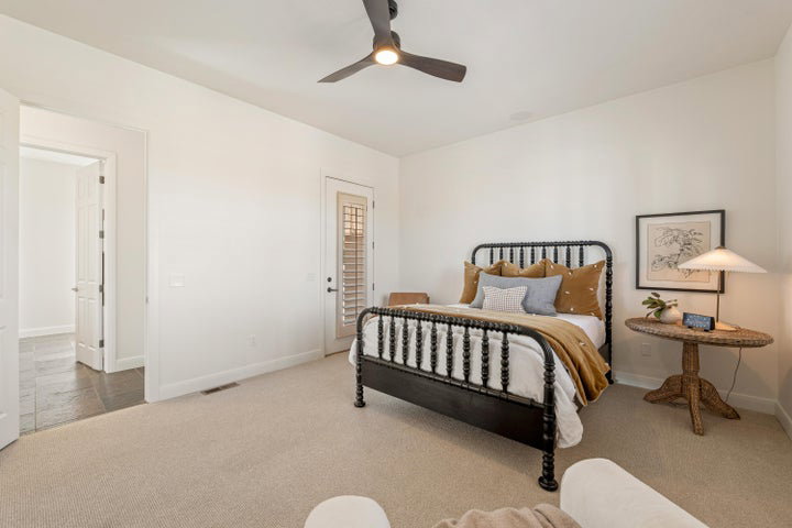 Bedroom featuring light carpet and a ceiling fan