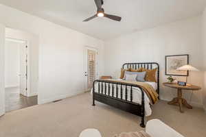 Bedroom featuring light carpet and a ceiling fan