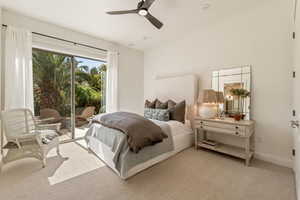 Bedroom featuring access to exterior, light carpet, vaulted ceiling, and ceiling fan