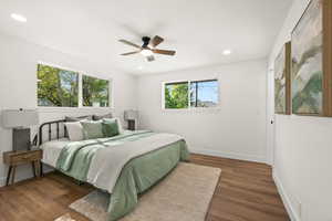 Bedroom with dark wood-style flooring, ceiling fan, and recessed lighting