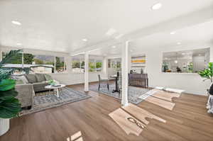 Living room with light wood-style floors and recessed lighting