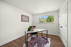 Office space featuring dark wood-type flooring and recessed lighting
