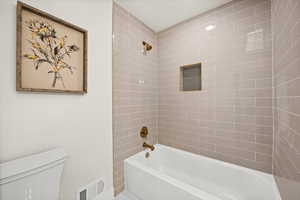 Full bathroom featuring toilet and bathing tub / shower combination