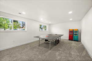 Recreation room with carpet floors and recessed lighting