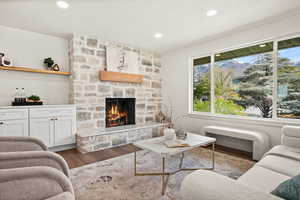 Living area featuring wood finished floors, a fireplace, recessed lighting, and a mountain view