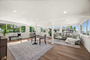 Office space featuring plenty of natural light, wood finished floors, and recessed lighting