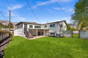 Rear view of house with a gate, a fenced backyard, a patio, and a mountain view