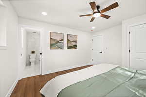 Bedroom with wood finished floors, a ceiling fan, recessed lighting, and ensuite bathroom
