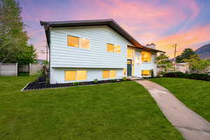 Split foyer home featuring a chimney and brick siding