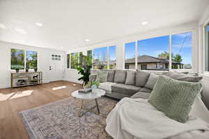 Living room with wood finished floors and recessed lighting
