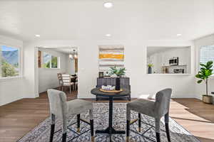 Dining area with wood finished floors and hanging lights