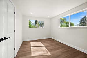 Unfurnished bedroom with dark wood finished floors and recessed lighting
