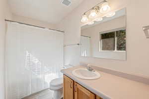 Full bathroom featuring vanity and shower / bath combo with shower curtain