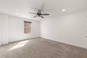 Unfurnished room with light carpet, a ceiling fan, and recessed lighting