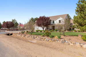 View of front of house featuring a front lawn and covered porch