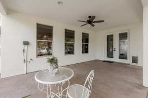 View of patio featuring french doors and a ceiling fan