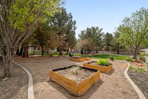 View of home's community featuring a garden and a patio area