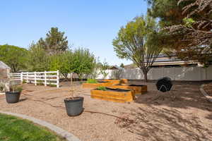 Fenced yard with a vegetable garden
