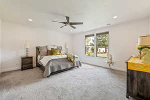 Bedroom with light carpet, a ceiling fan, and recessed lighting