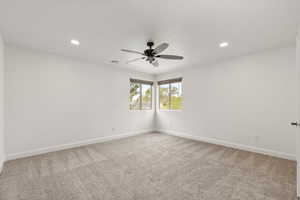 Unfurnished room with light carpet, recessed lighting, and a ceiling fan