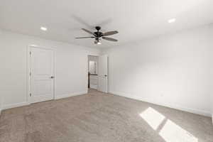 Unfurnished bedroom featuring light carpet, a ceiling fan, and recessed lighting