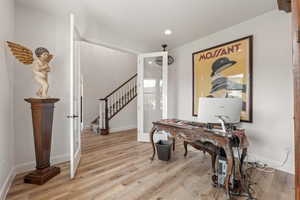 Home office featuring light wood-style floors and recessed lighting