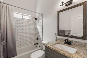 Bathroom featuring vanity and shower / tub combo