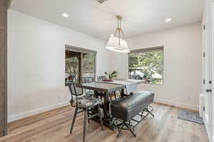 Dining area with light wood-type flooring, plenty of natural light, and recessed lighting