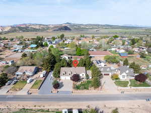 Aerial view of property's location with nearby suburban area and mountains