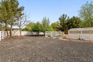 Fenced yard with a garden and an outbuilding