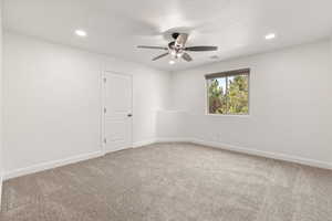 Unfurnished room featuring carpet, ceiling fan, and recessed lighting