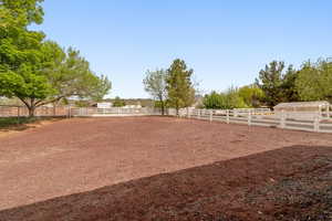 View of yard featuring an enclosed horse arena and a view of rural / pastoral area