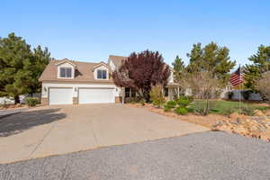 View of front of home featuring stone siding and concrete driveway